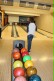 Man sieht auf dem Foto verschiedene Bowlingkugeln. Die Kugeln haben unterschiedliche Farben und ein unterschiedliches Gewicht.